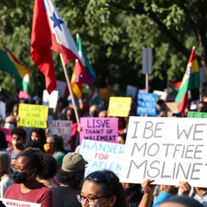 Participants holding signs at the No Kings Day protest in Mississippi